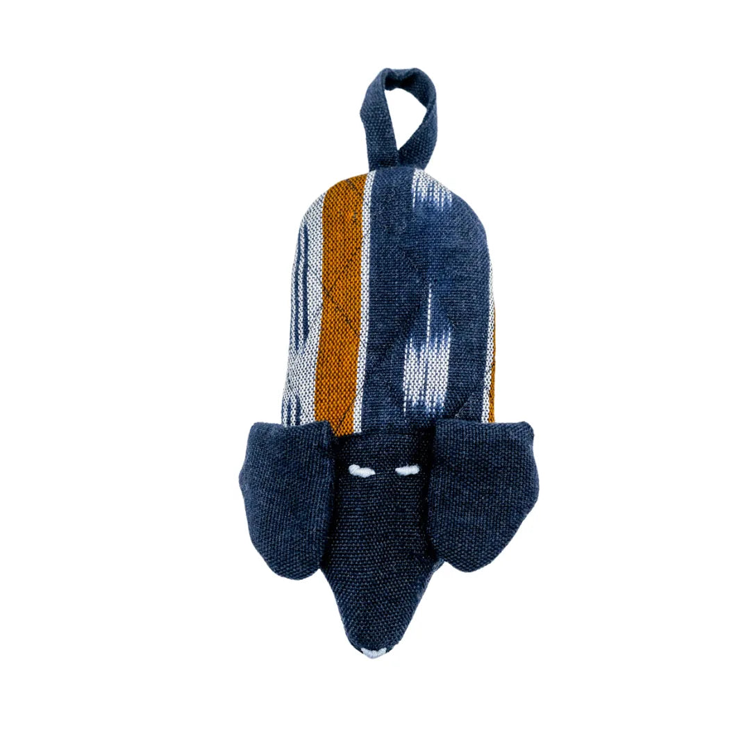Charming dog-shaped skillet handle holder in navy with vibrant stripes, handcrafted from cotton for heat resistance.