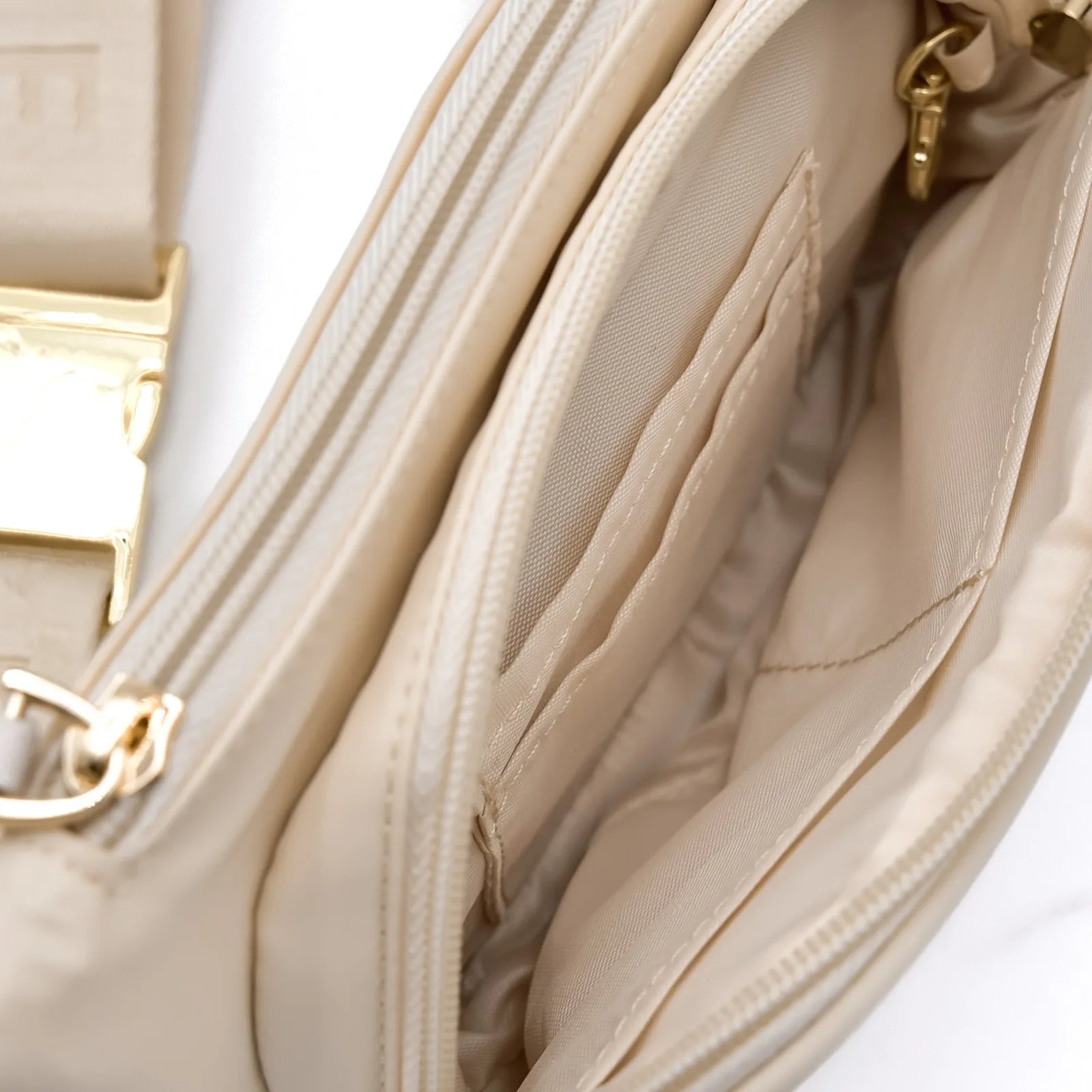 Beige Elise Galleria dog walking bag interior, featuring multiple pockets and a concealed zipper, highlighted with gold ha...