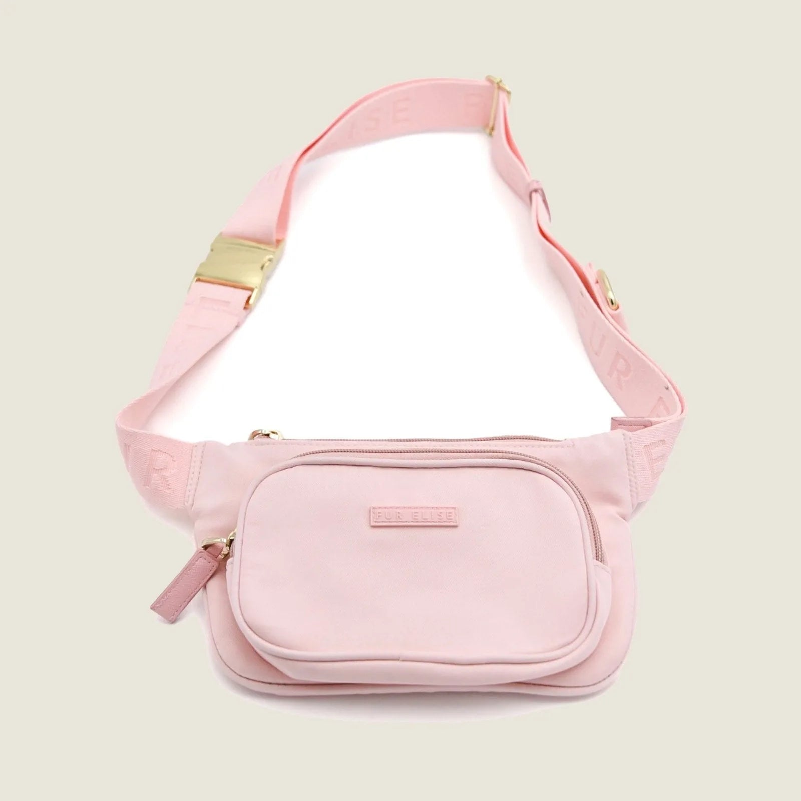 Belt bag in soft rose with gold zipper, featuring multiple pockets and an adjustable strap for dog walking essentials.