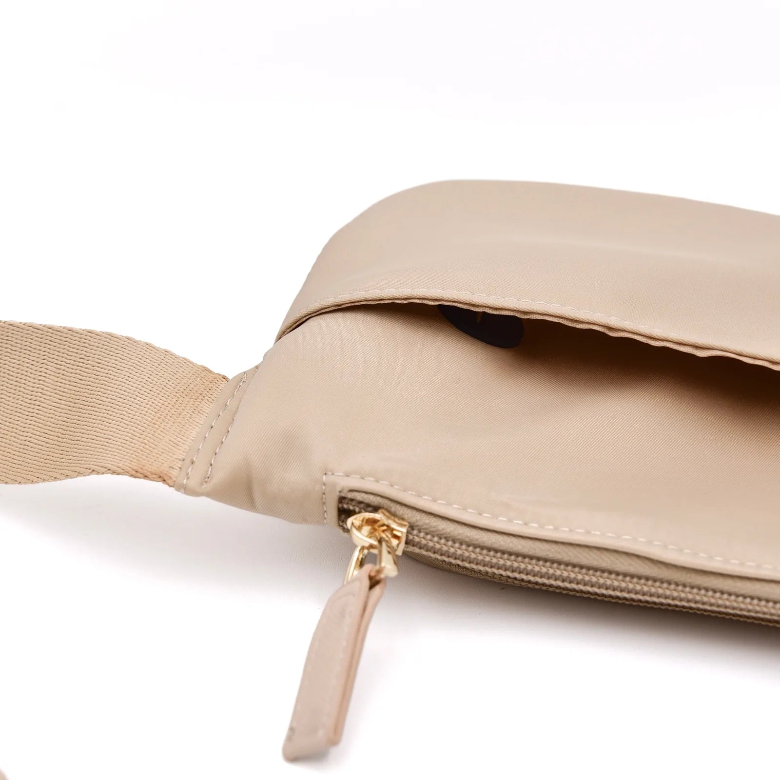Lightweight sand-colored dog walking bag with gold zipper details and adjustable strap, designed for hands-free convenience.