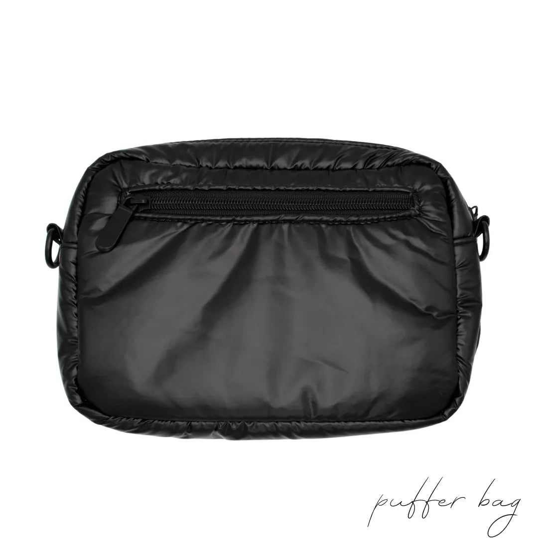Black puffer bag with a zipper pocket, designed for dog owners to carry essentials during walks.