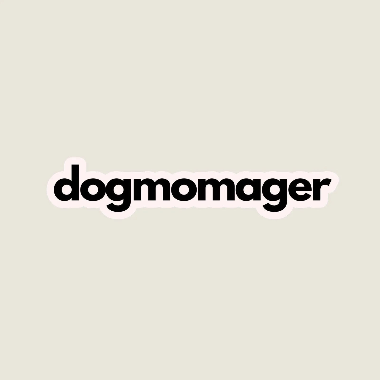 Black "dogmomager" sticker with a smooth matte finish on a light beige background. Perfect for dog mom pride.