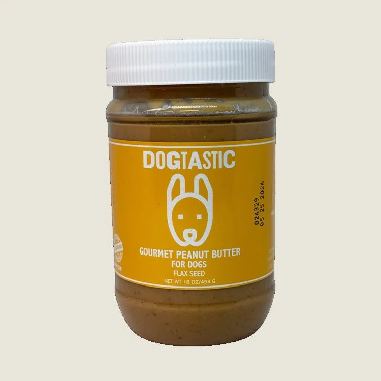 Creamy Dogtastic peanut butter jar with a vibrant yellow label featuring a dog graphic and "GOURMET PEANUT BUTTER FOR DOGS."