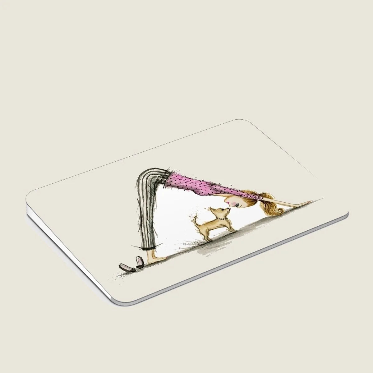 Downward Dog design on Mac trackpad featuring a woman stretching with her dog, adding style to any workspace.