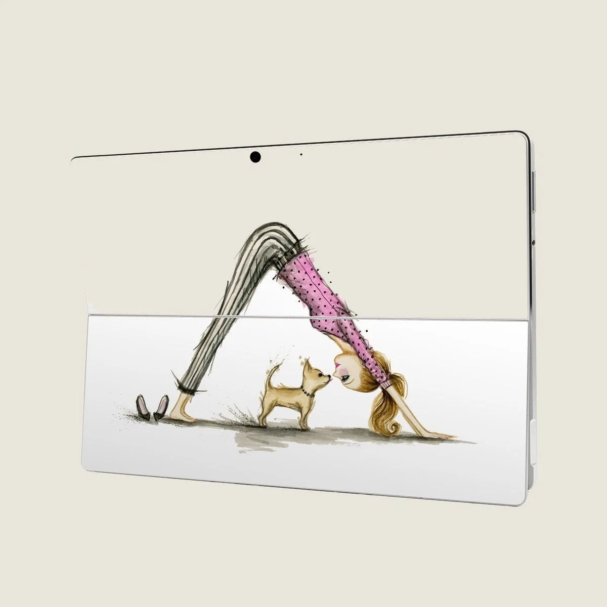 Skin design features a woman doing yoga with a dog in a playful pose, on a sleek Surface Pro tablet.
