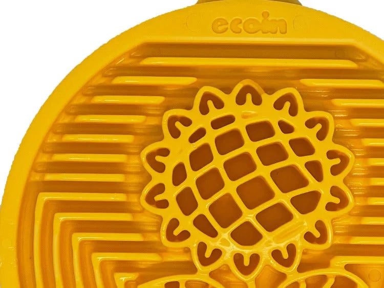 Yellow nylon lick mat with textured sunflower design, promoting slow licking and mental engagement for dogs.