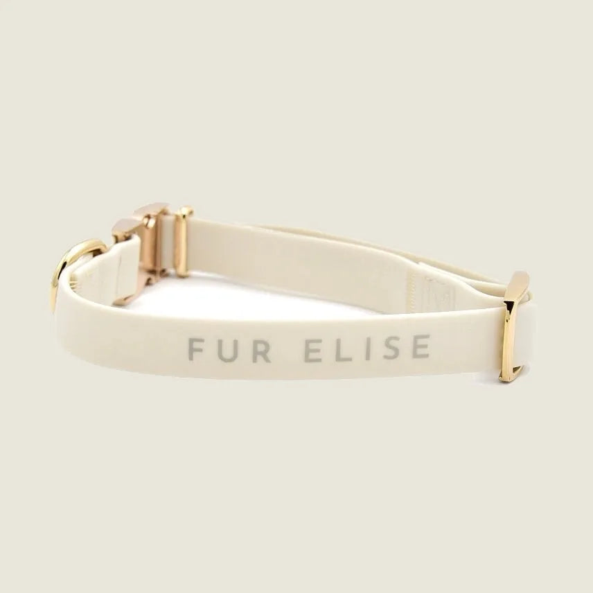 Elise Collar in Bone featuring a soft matte texture and elegant gold hardware, displaying "FUR ELISE" branding.