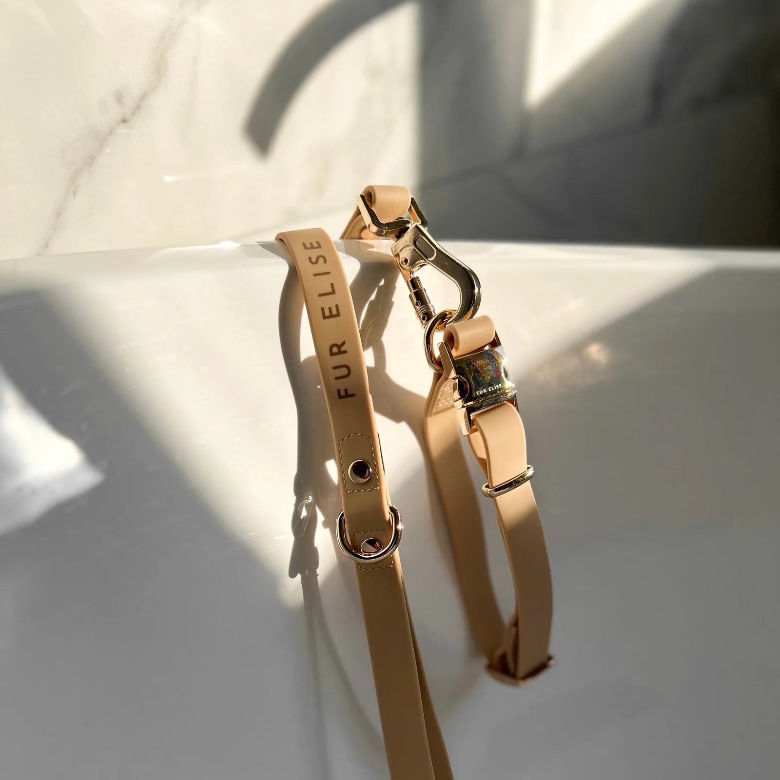 Elise Collar & Leash Set in sand color, featuring lightweight rubbery material and light gold hardware on a white surface.