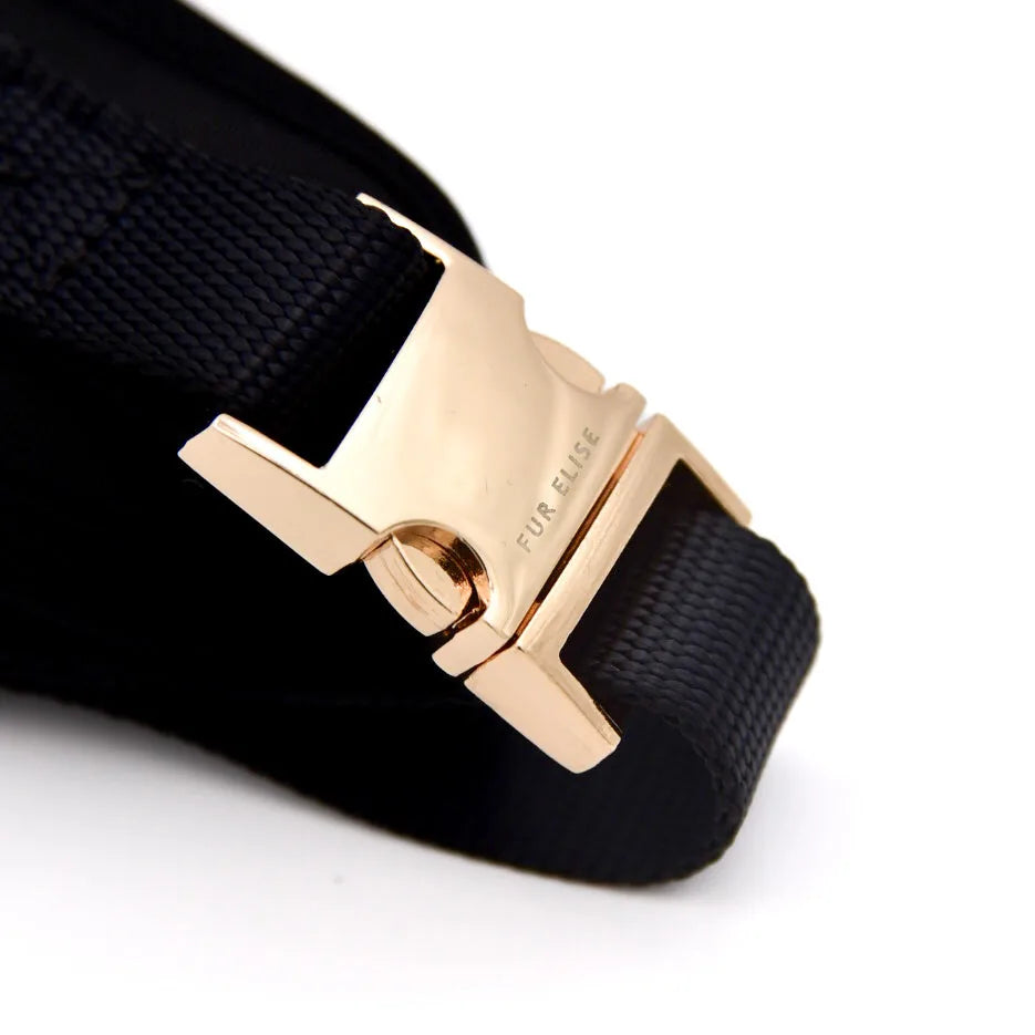 Gold buckle detail on the black Elise harness, showcasing sleek design and adjustable strap for a secure fit.