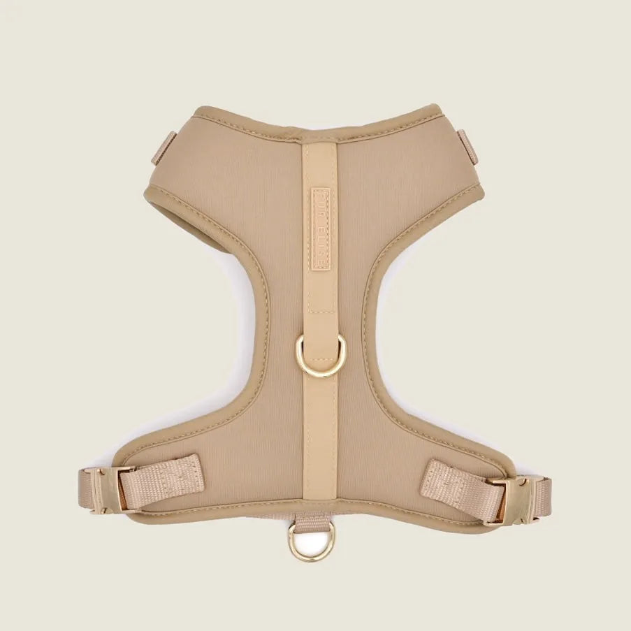 Soft sand-colored neoprene harness with breathable mesh lining and adjustable buckles, designed for comfort during walks.