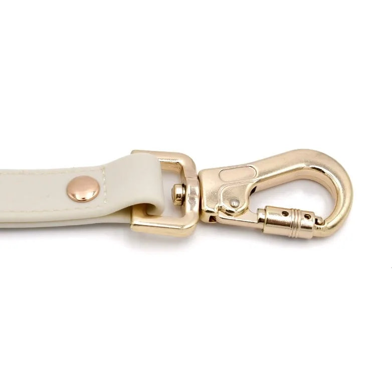 Elise Galleria Elise Leash in Bone with a gold slide-lock carabiner, featuring a soft, weather-resistant strap.