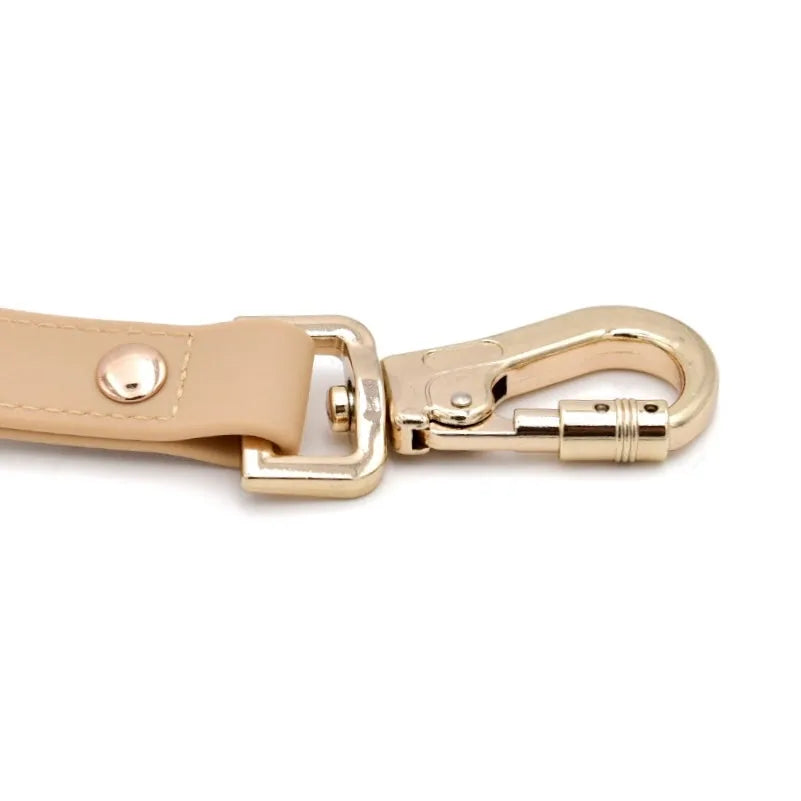 Elise Leash in Sand featuring a light gold zinc alloy carabiner and durable rubber-coated webbing.