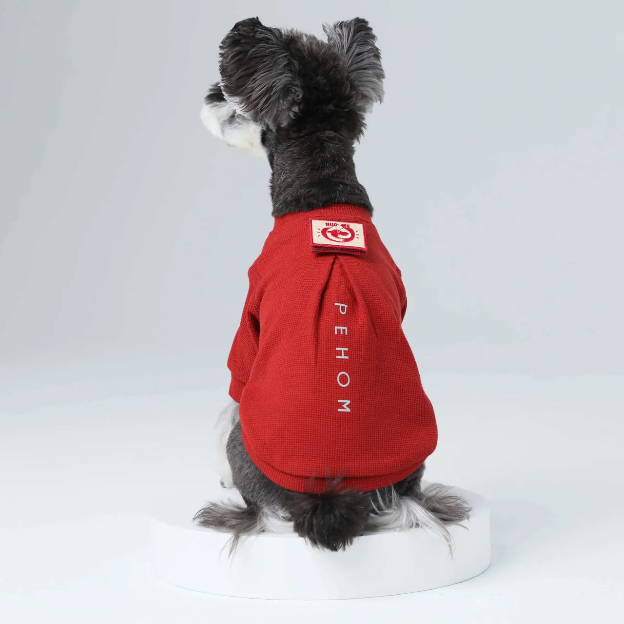 Red waffle plaid dog t-shirt featuring an embroidered patch and reflective print, perfect for walks and everyday wear.