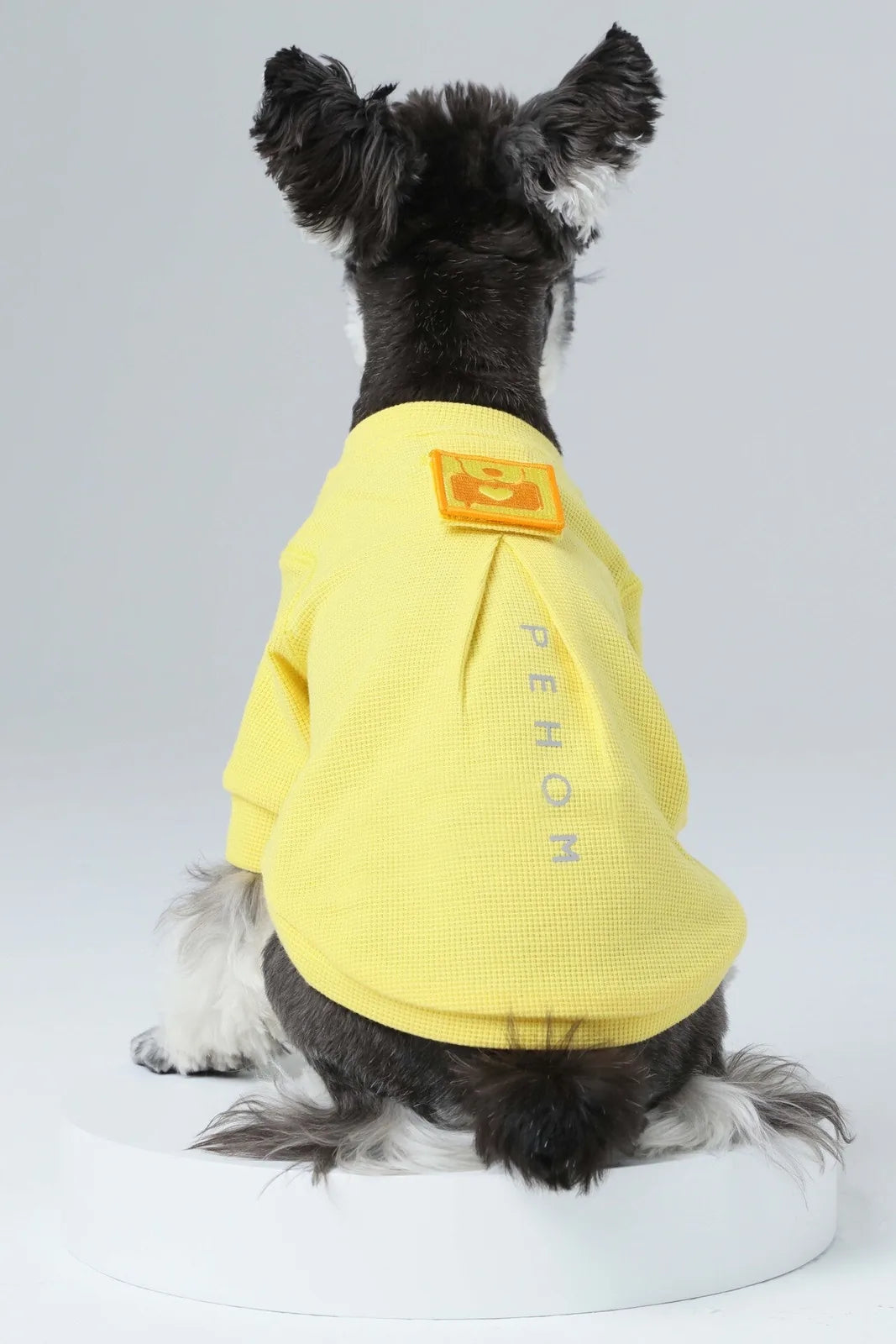 Yellow waffle plaid t-shirt for dogs, featuring an embroidered patch and reflective detail, showcased from the back.