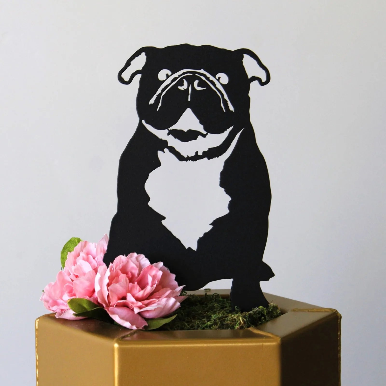 Black metal silhouette of an English Bulldog with pink flowers, adding a touch of dog-themed decor to any space.