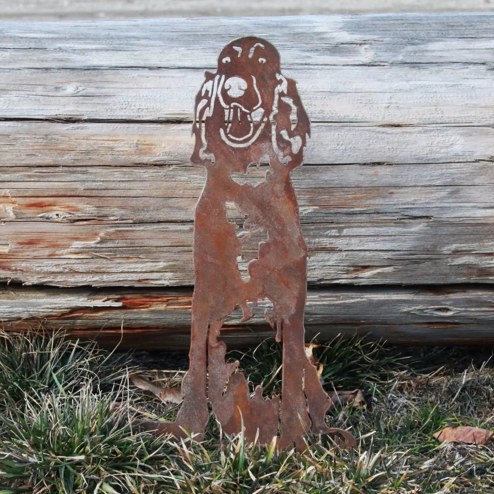 Rusty Corten steel English Setter silhouette with detailed features, set against grass and weathered wood.