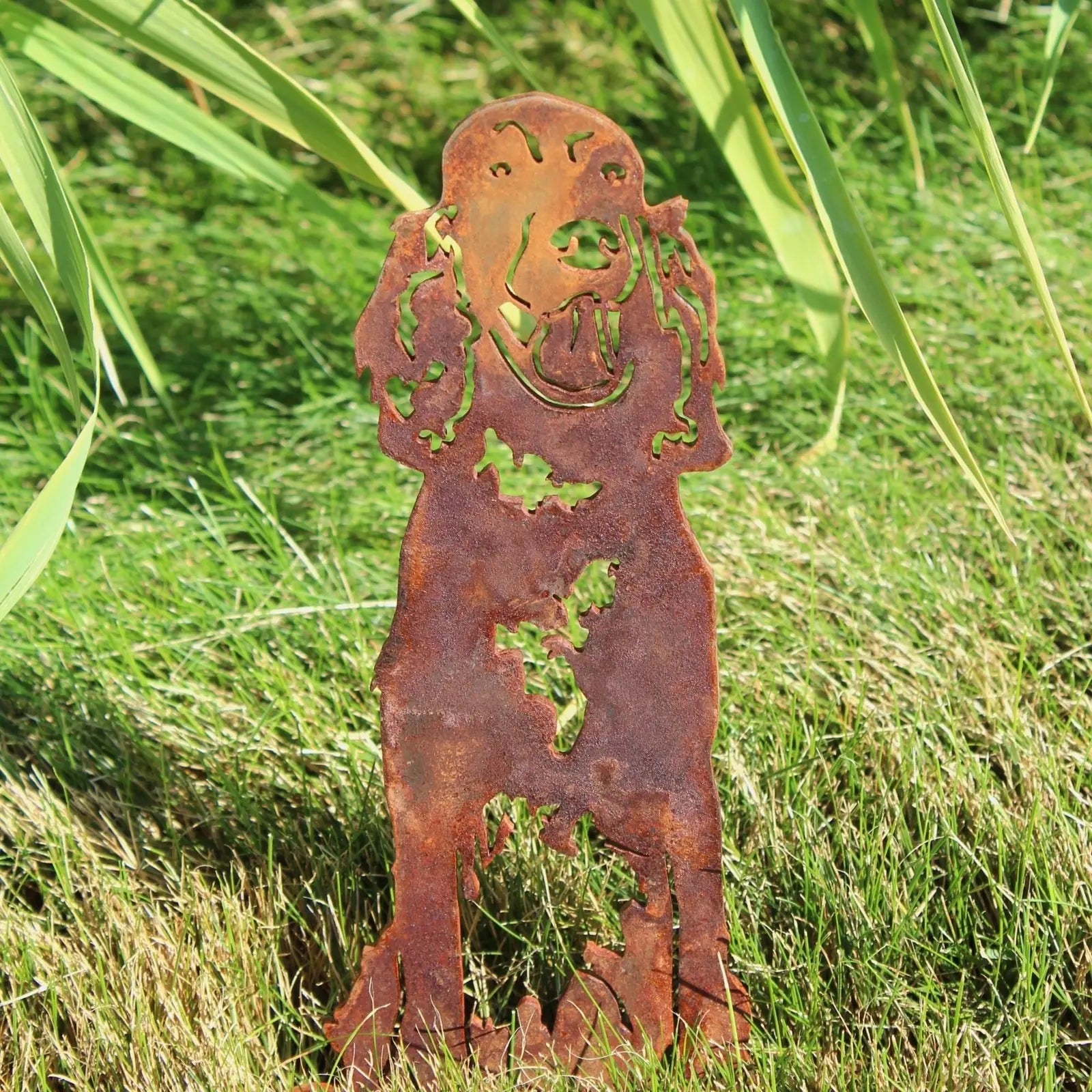 Rusty Corten steel silhouette of an English Setter standing in grass, ideal for outdoor dog decor.