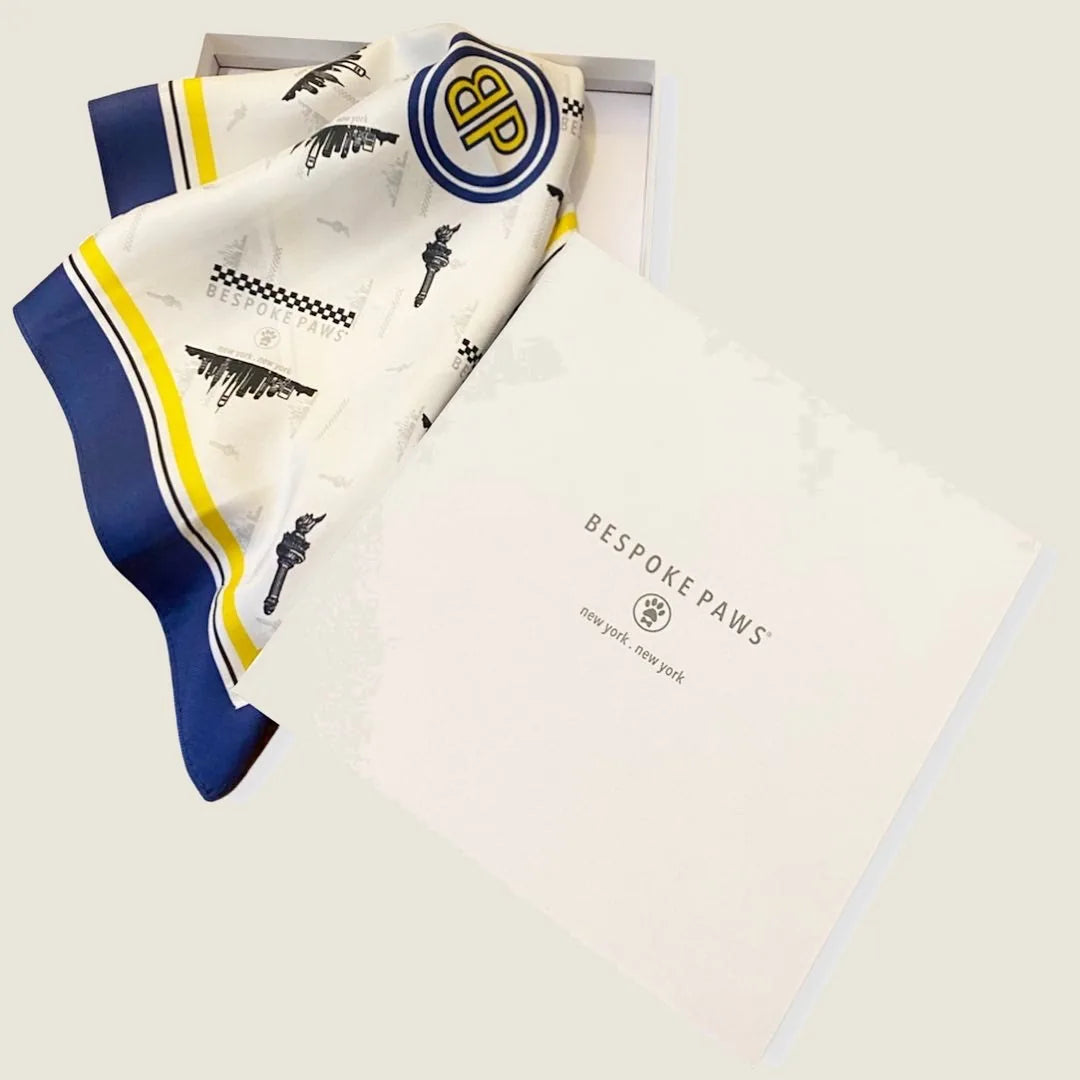 Elegant Erin silk twill dog scarf in white with NYC graphics, nestled in a BESPOKE PAWS gift box.