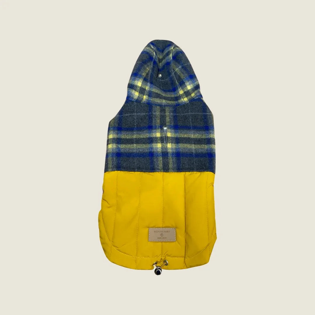 Reversible dog coat in navy plaid and yellow, featuring a cozy puffer design with a hood for warmth and style.