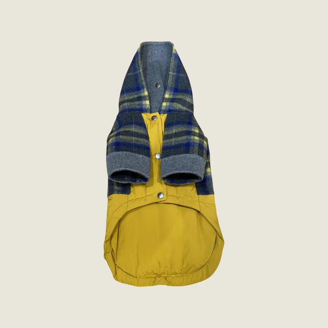 Reversible dog coat in navy plaid and yellow, featuring a cozy puffer design and hood for warmth in winter weather.