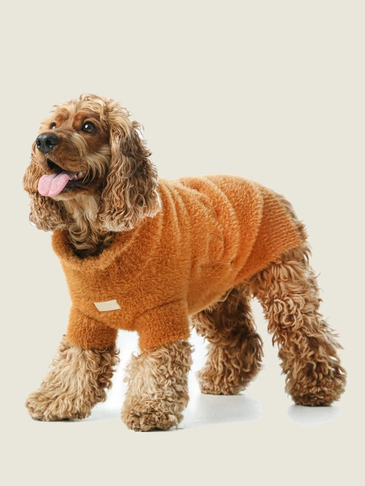 Cozy orange Eskimo fuzzy sweater for dogs, featuring a soft texture and comfortable fit, perfect for chilly days.