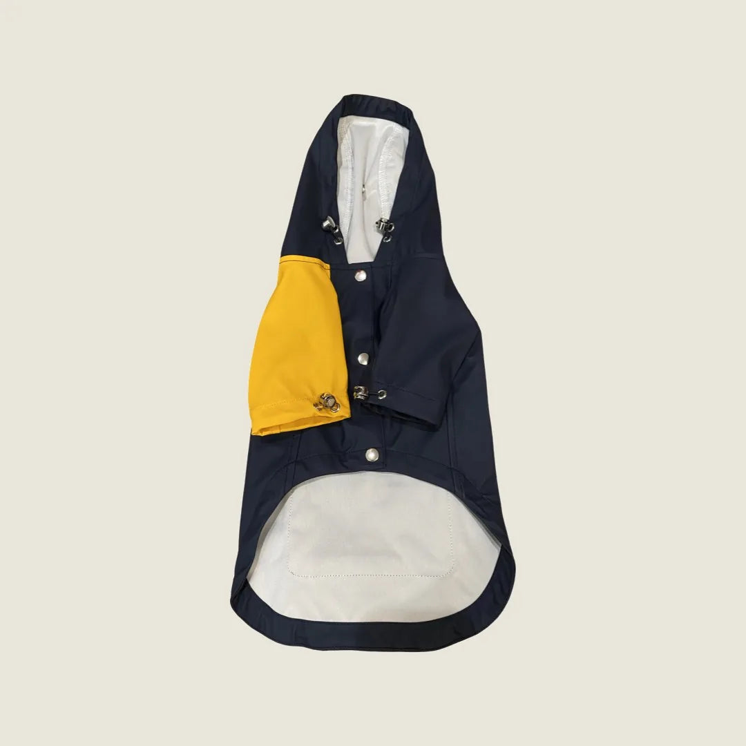 Navy and yellow water-repellent pet raincoat with adjustable straps and back pocket, perfect for keeping dogs dry.
