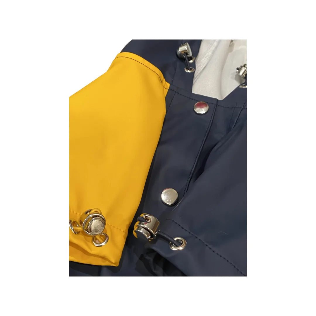 Navy and yellow color block waterproof pet raincoat, featuring adjustable straps and metallic snap closures.
