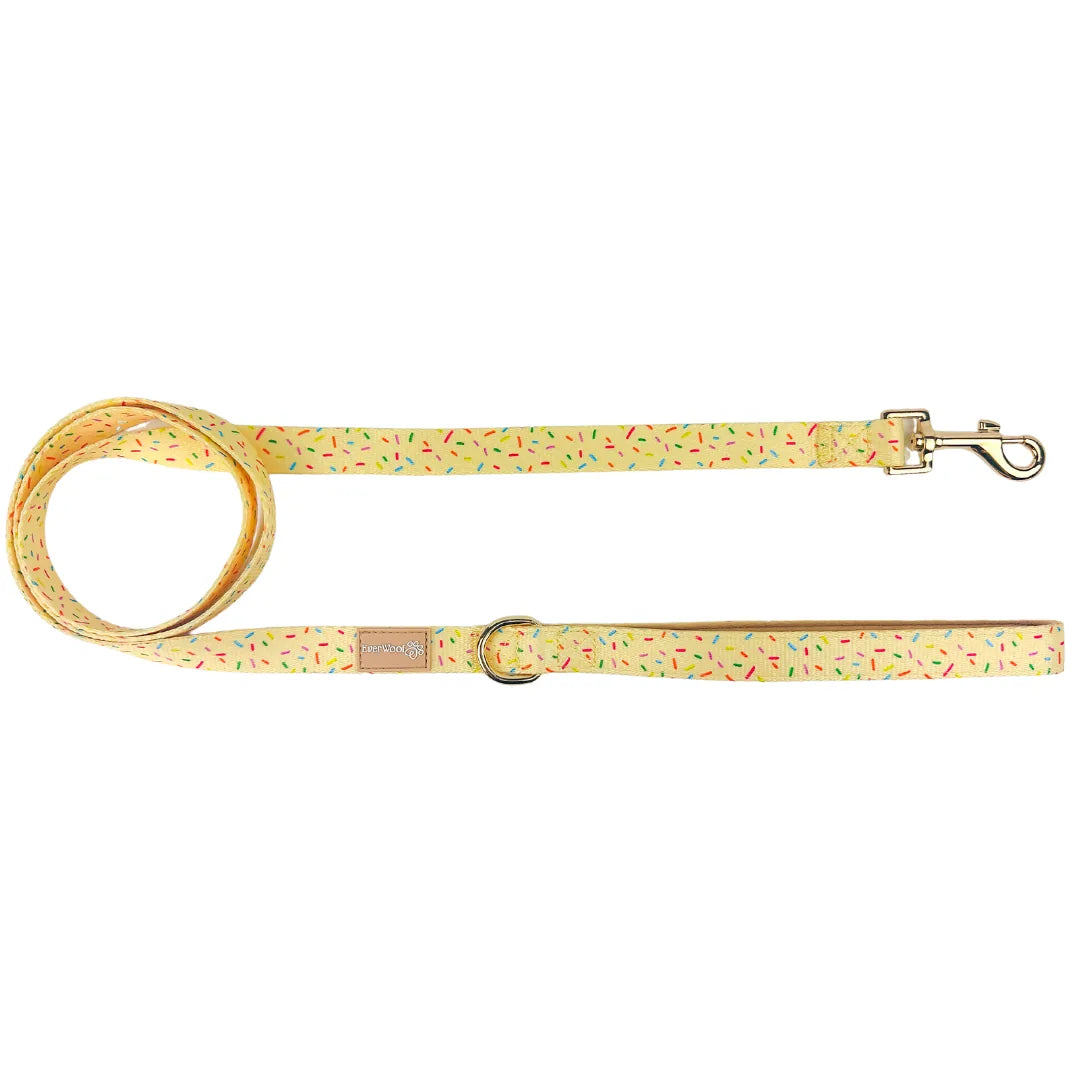 Yellow leash with colorful confetti pattern, featuring a secure metal clip, suitable for everyday dog walking.