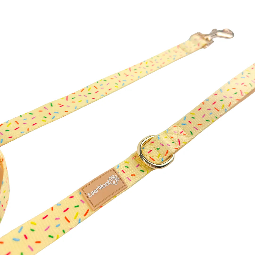 Bright yellow dog leash with a sprinkle pattern, featuring a neoprene padded handle and a zinc alloy metal clip.
