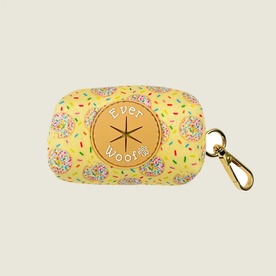 Yellow waste bag holder with donut pattern and gold clip, featuring 'Ever Woof' logo on front.