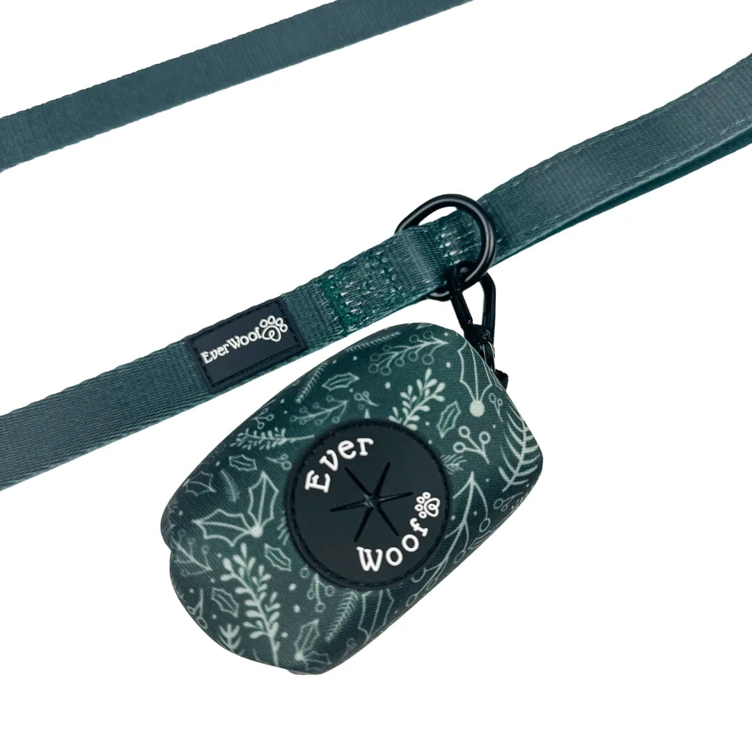 Evergreen green waste bag holder with floral design, featuring a zinc alloy hook for easy attachment to leashes.