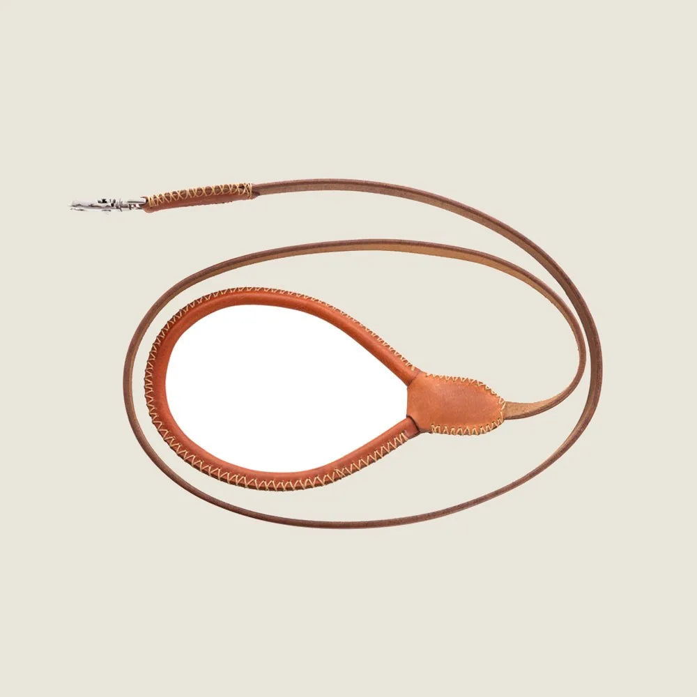 Stylish caramel leather dog leash with special stitching and flared clasp, offering a classic and durable design.