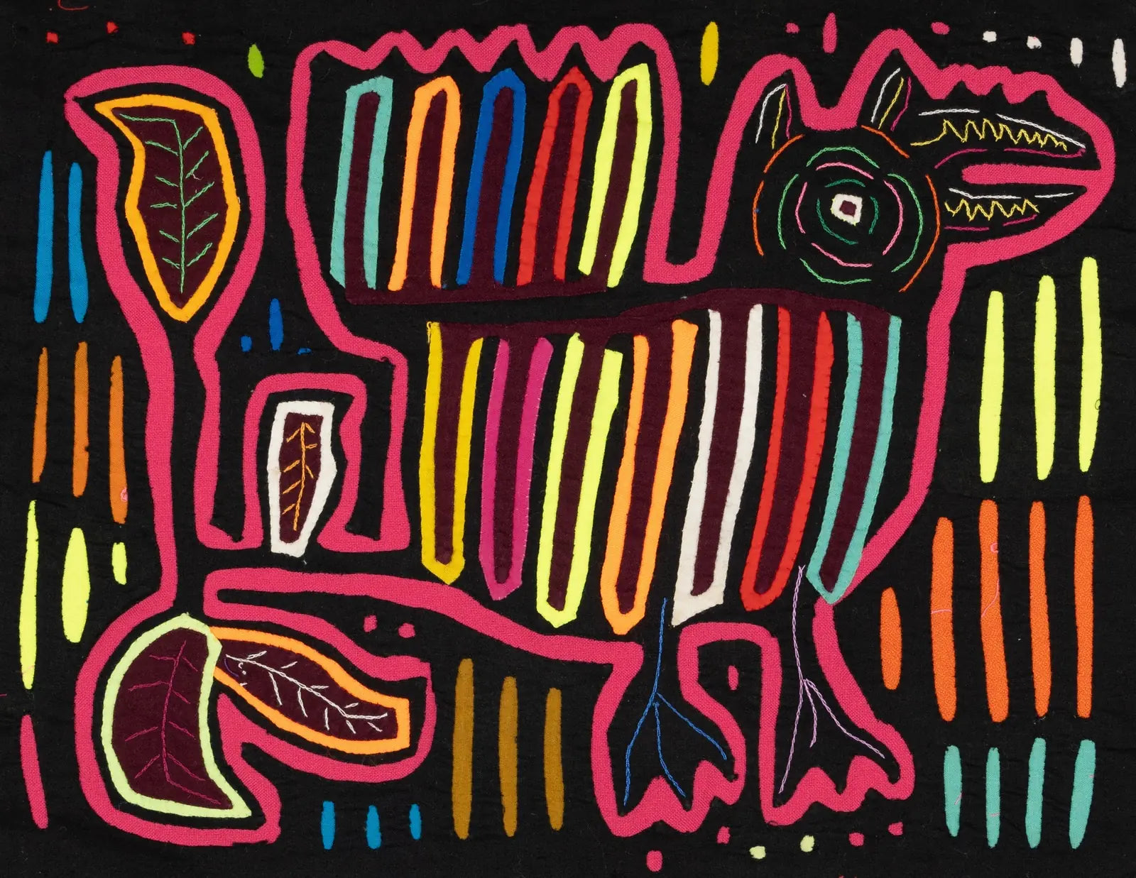 Colorful hand-stitched Mola tapestry featuring a stylized dog design with geometric patterns on a black background.