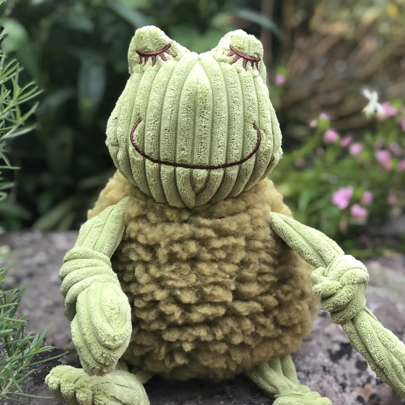 Fiona Frog plush dog toy in green and tan, featuring a textured design and knotted limbs for interactive play.