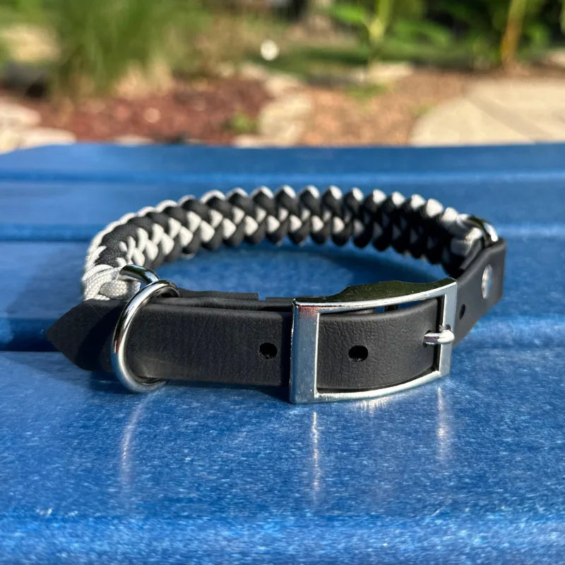 Hand-braided fishtail dog collar in black and smoke gray nylon with a sturdy D-ring and black buckle.