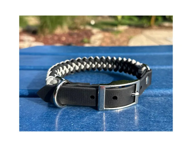 Handcrafted fishtail dog collar in black and smoke gray nylon paracord with a black buckle and D-ring.