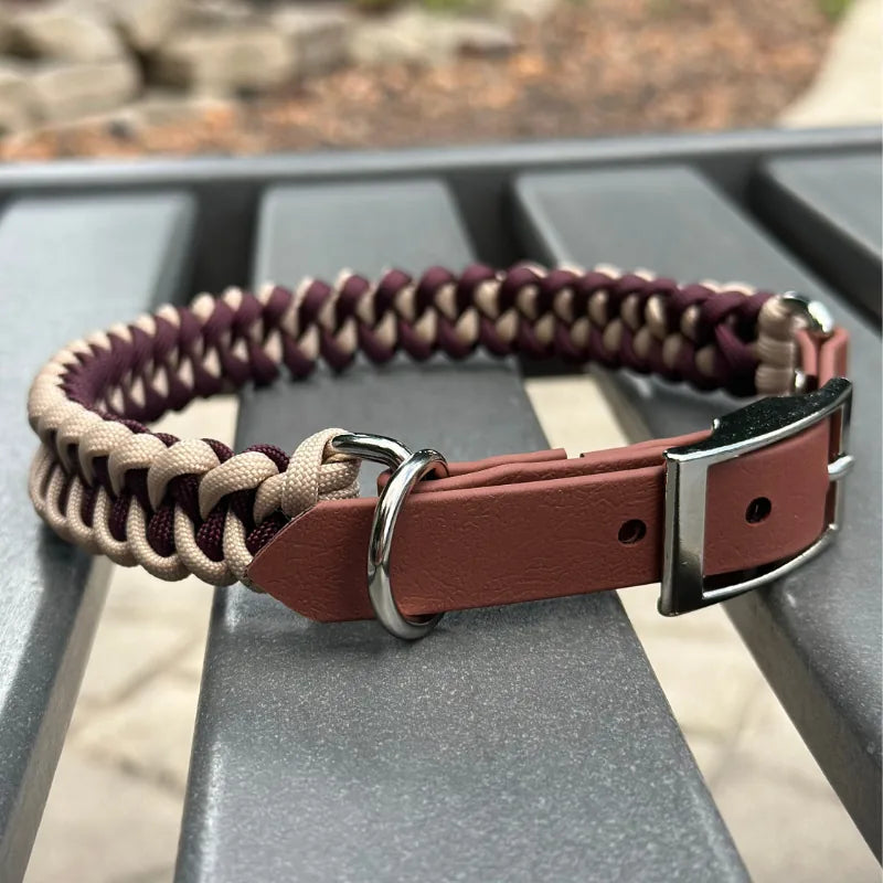 Handmade braided dog collar in burgundy and cream nylon paracord, featuring a medium brown buckle and D-ring.