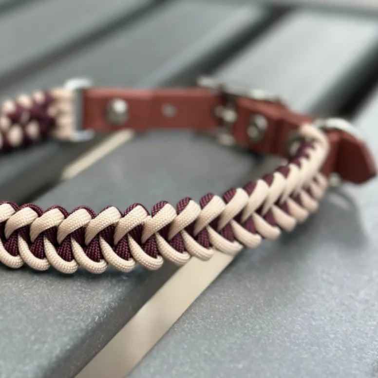 Handmade braided dog collar in burgundy and cream nylon paracord with a medium brown buckle and strong D-ring.