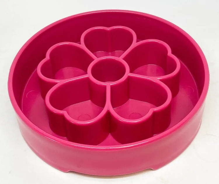 Flower-shaped slow feeder dog bowl in bright pink, featuring segmented chambers for healthy eating and enrichment.