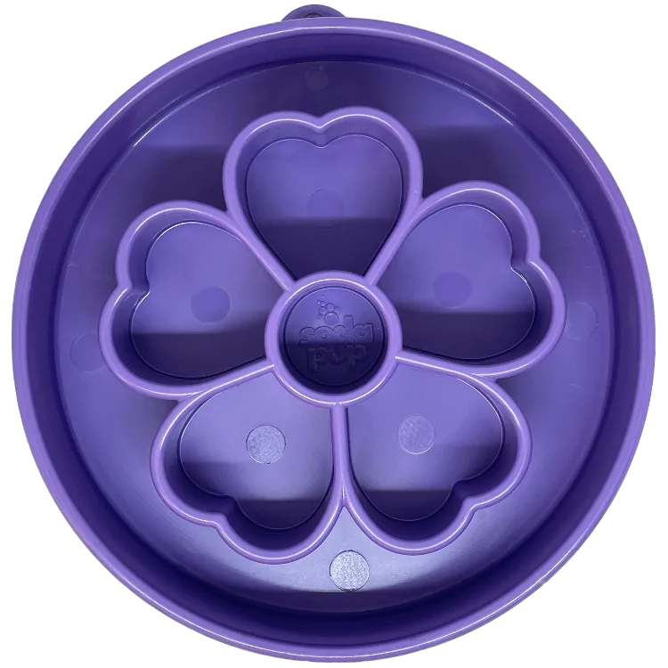Purple flower-shaped slow feeder dog bowl with segmented chambers for slow eating and mental stimulation.
