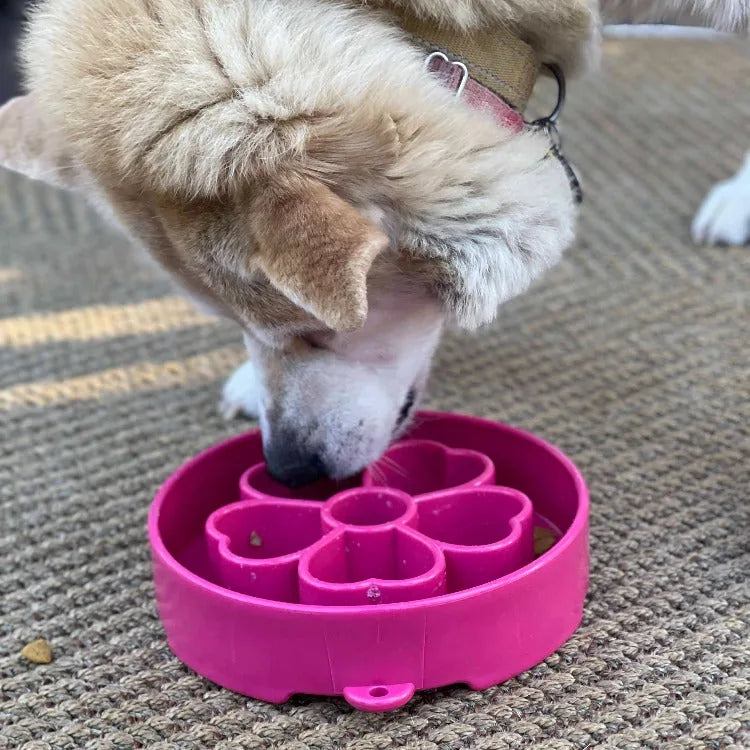 Flower-shaped pink slow feeder bowl designed for dogs, featuring segmented chambers for engaging meals.