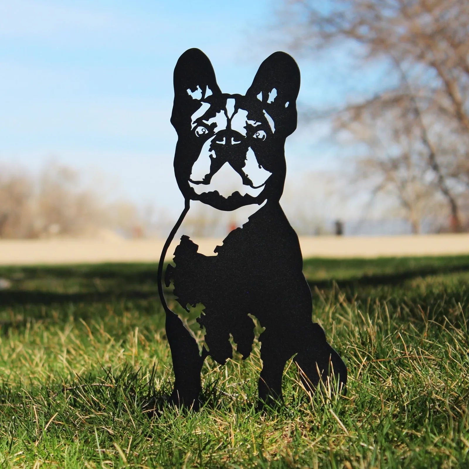 Handmade black metal silhouette of a French Bulldog standing on grass, perfect for home or garden décor.
