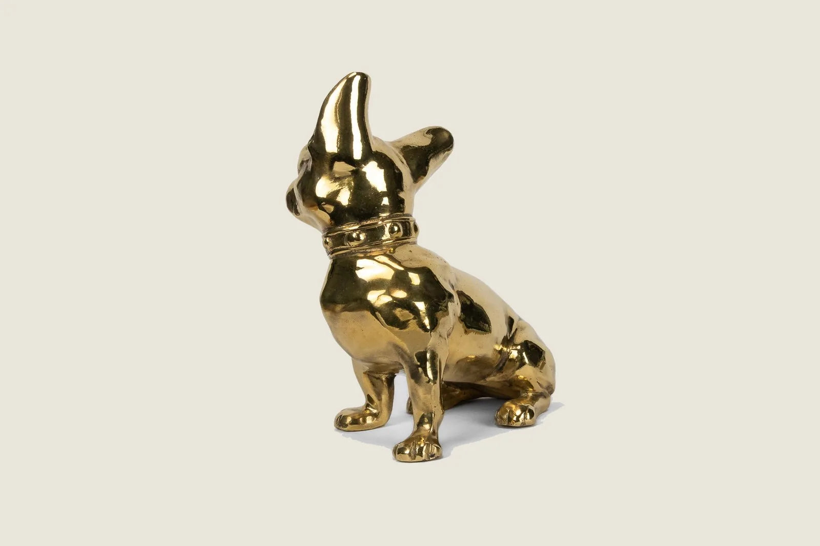 Handcrafted brass French Bulldog sculpture with a glossy finish, featuring unique details and a vintage-inspired design.