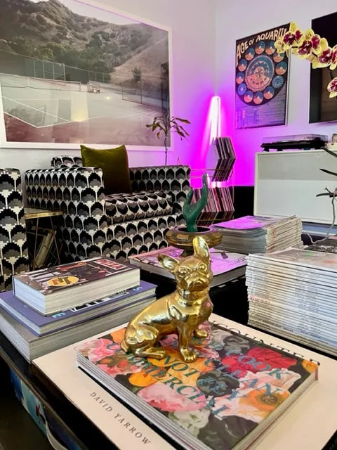 Brass French Bulldog sculpture on stacked magazines, showcasing a glossy finish and vintage-inspired design in a stylish d...