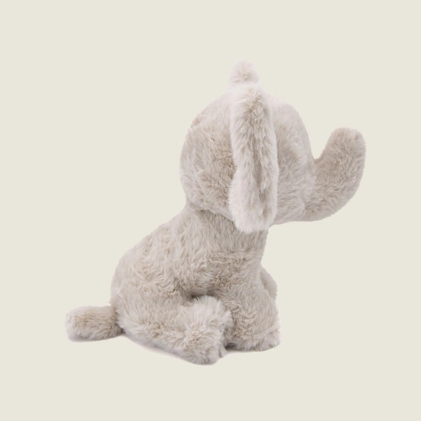 Soft, beige plush elephant toy with large ears and a curled tail, ideal for gentle dog play and cuddling.