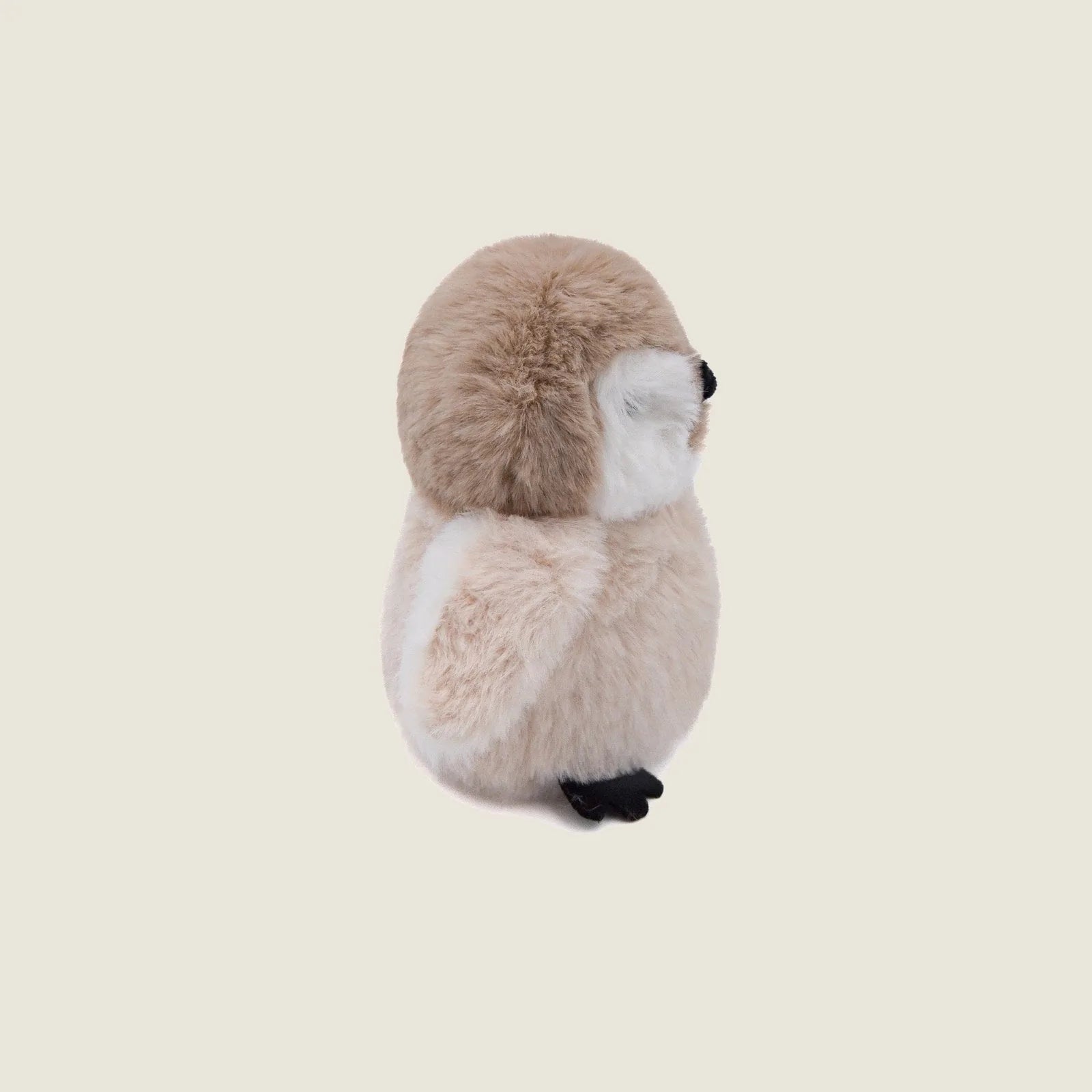 Soft beige Pegy the Penguin plush toy with a round head, crinkly wings, and hand-stitched cloth eyes, perfect for gentle p...