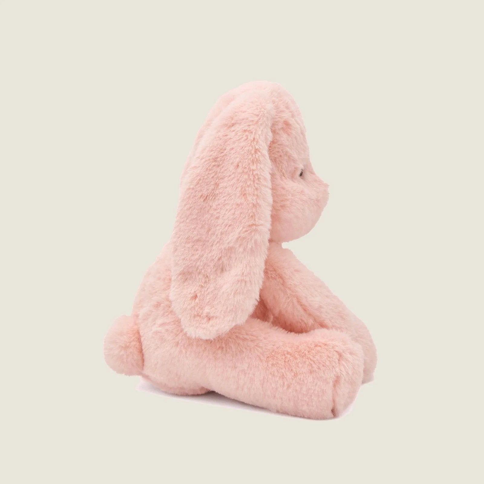 Soft pink plush bunny toy with long ears, designed for gentle play and cuddling by dogs.