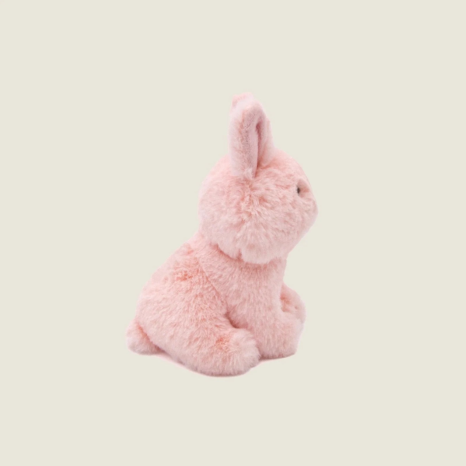 Mini Ruby the Rabbit plush toy in soft pink with long ears, perfect for dogs to cuddle and play with.