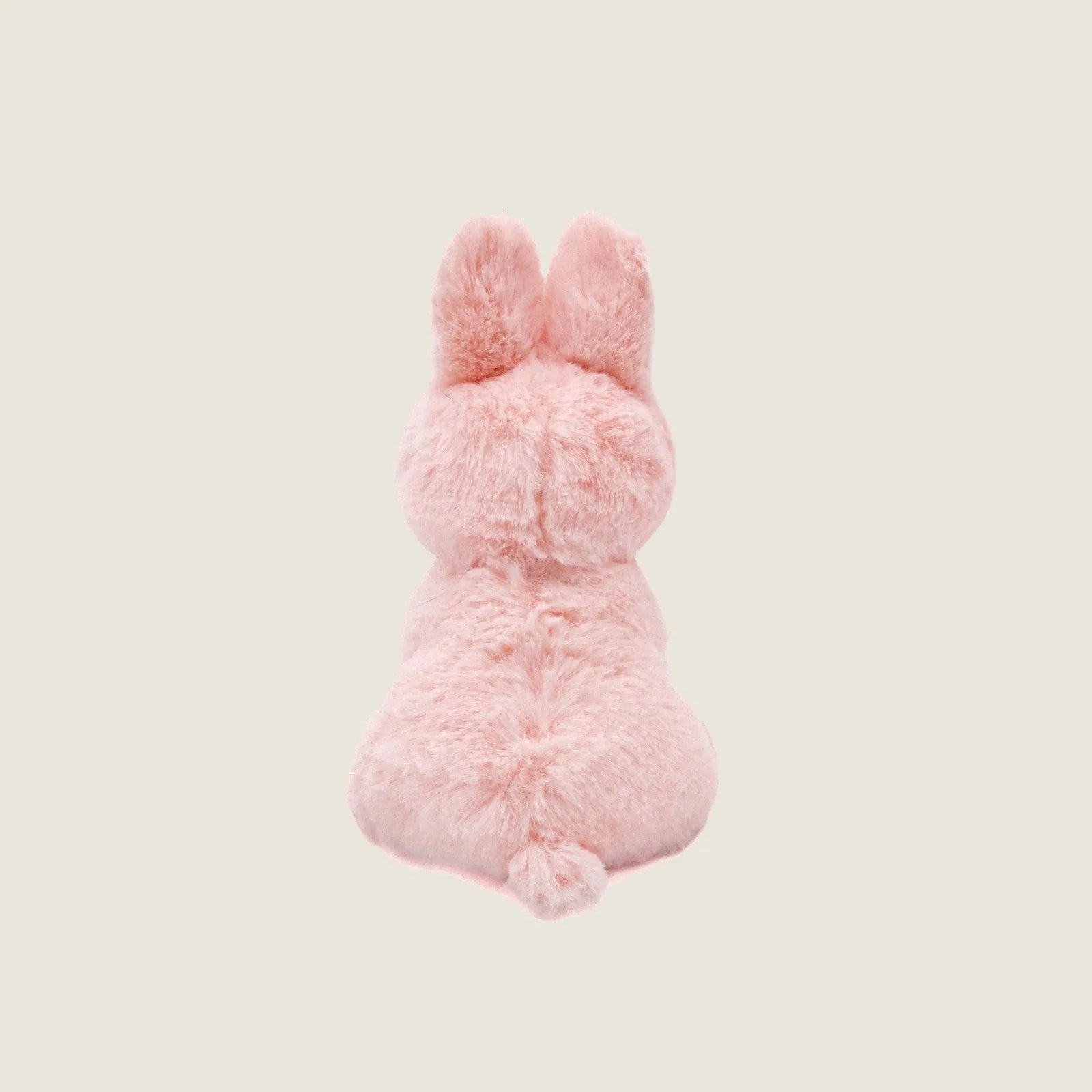 Mini plush Ruby the Rabbit dog toy in soft pink faux fur, featuring long ears and a round shape, perfect for snuggling.