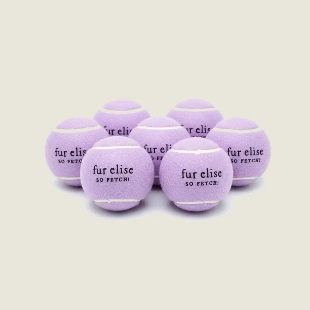 Lilac tennis balls in a pack of 7, featuring "fur elise SO FETCH!" text, designed for durable dog play.